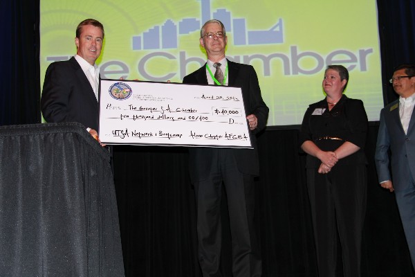 Bill Morrow (l), chapter president, presents a $10,000 check to Greg White, director of the University of Texas at San Antonio's Center for Infrastructure Assurance and Security, in April.